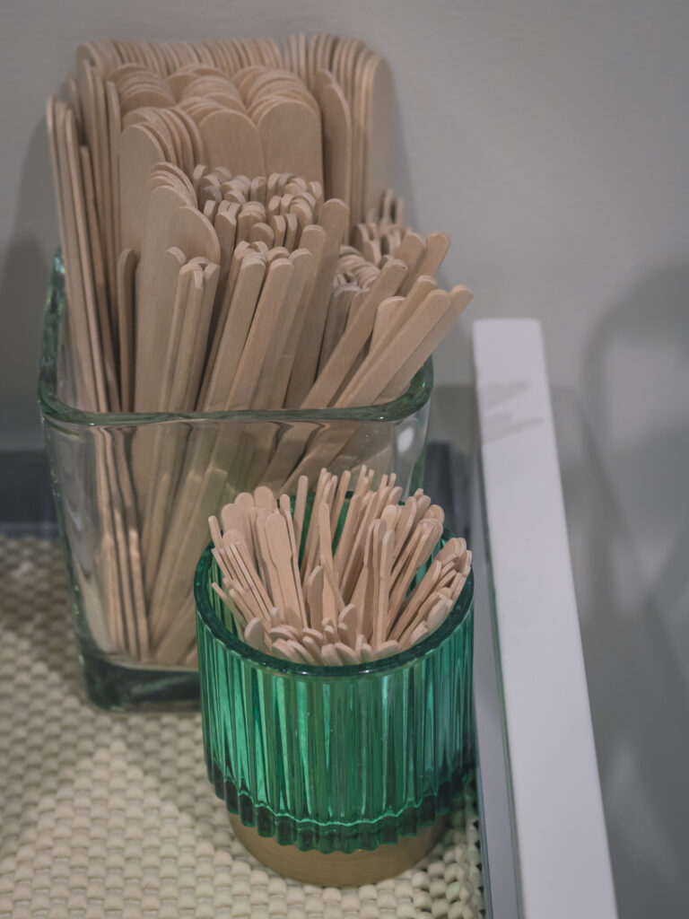 An image of 100 or so Popsicle sticks of various sizes in glass jars
